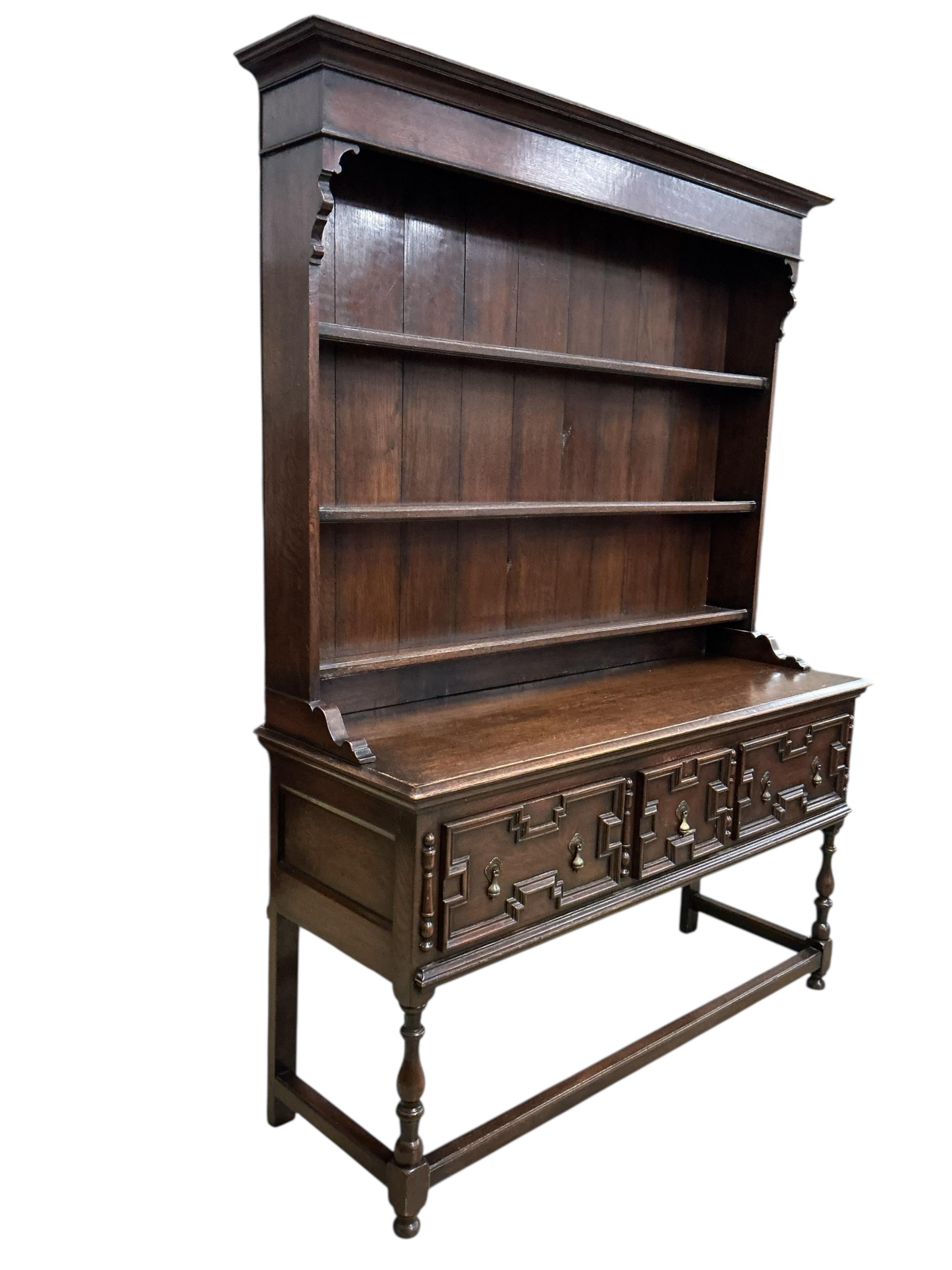 An early 20th century Jacobean Revival oak dresser with boarded rack, width 152cm, depth 51cm, height 206cm